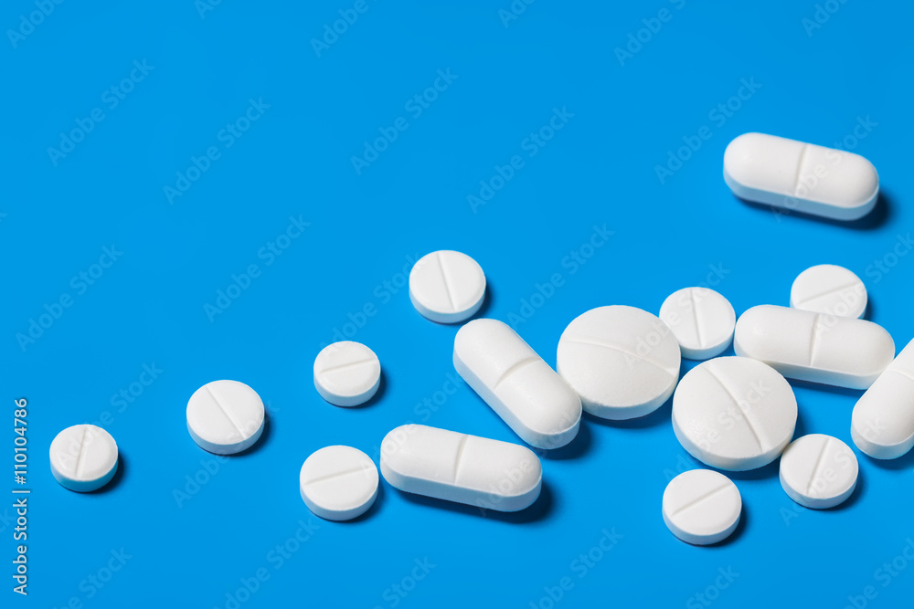 Tablets close up on blue background.Bright Medical background Tablets close up on blue background.Bright Medical background