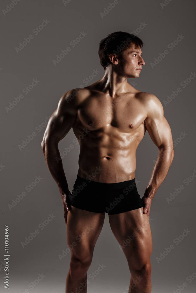 Strong Athletic Man showing muscular body and sixpack abs. Showing his body. FITNESS MODEL. Great for Underwear Commercial. Wet body Strong Athletic Man showing muscular body and sixpack abs. Showing his body. FITNESS MODEL. Great for Underwear Commercial. Wet body