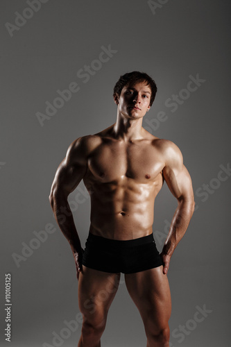 Strong Athletic Man showing muscular body and sixpack abs. Showing his body. FITNESS MODEL. Great for Underwear Commercial. Wet body
