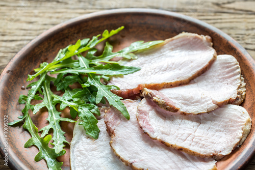 Baked meat with fresh rocket salad