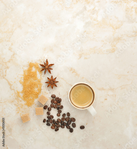 coffee, cane sugar, spice anise on a marble background.