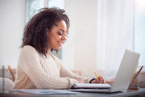 Cute young woman studying at the table