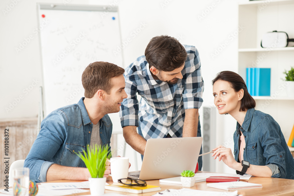Talented three colleagues are discussing their work Talented three colleagues are discussing their work
