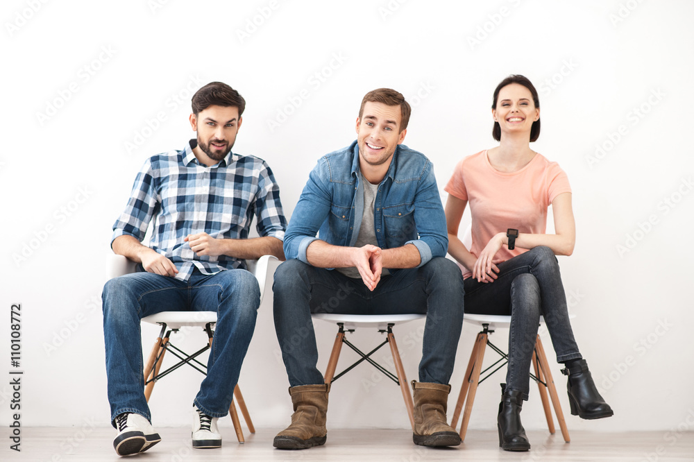 Cheerful guys and lady waiting for job interview Cheerful guys and lady waiting for job interview