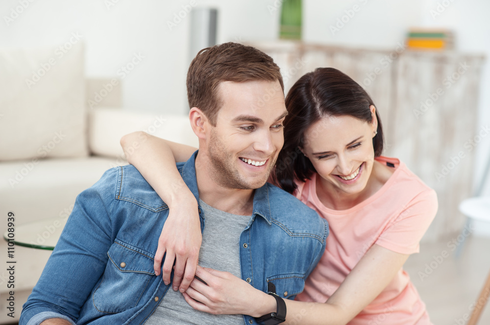 Cheerful loving couple is relaxing on flooring