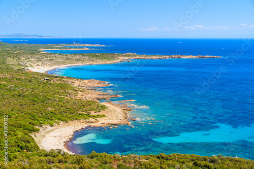 A view of beautiful secluded beach and blue sea on coast of Corsica island, France