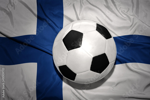 black and white football ball on the national flag of finland