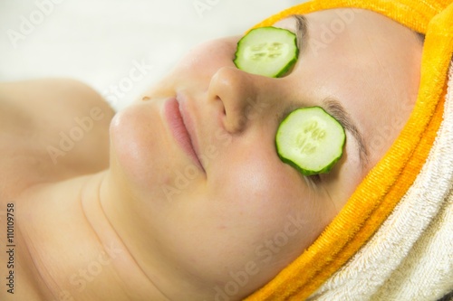 Closeup woman on face with cucumber