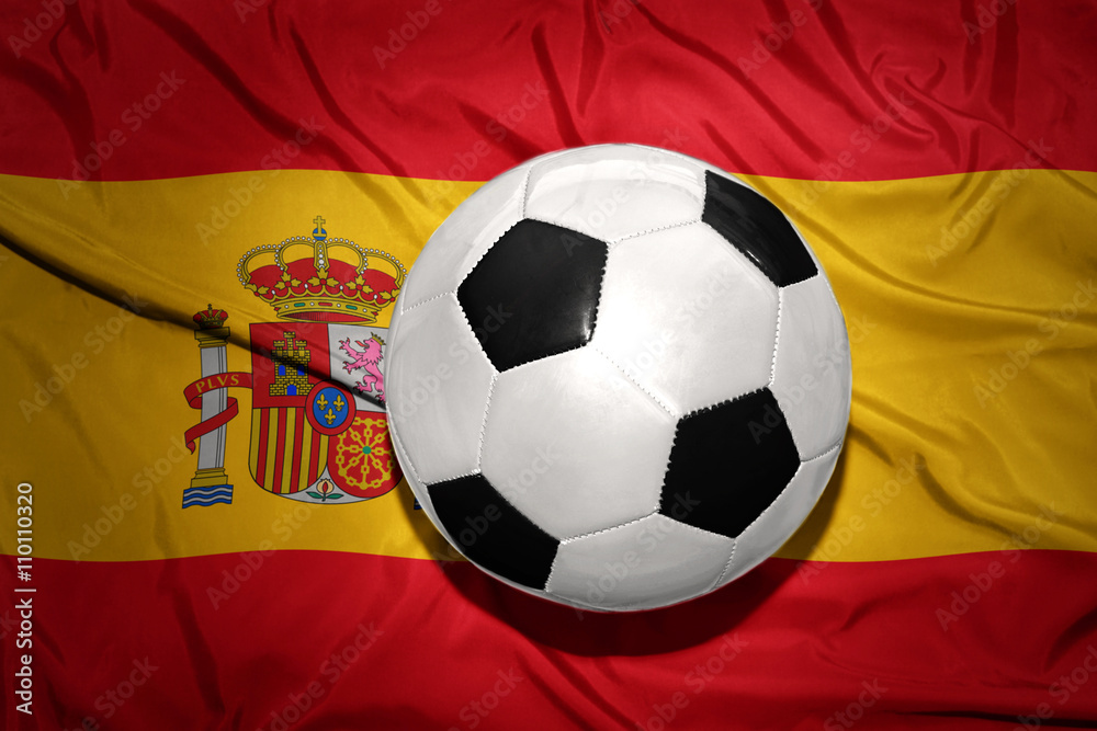 Fototapeta premium black and white football ball on the national flag of spain