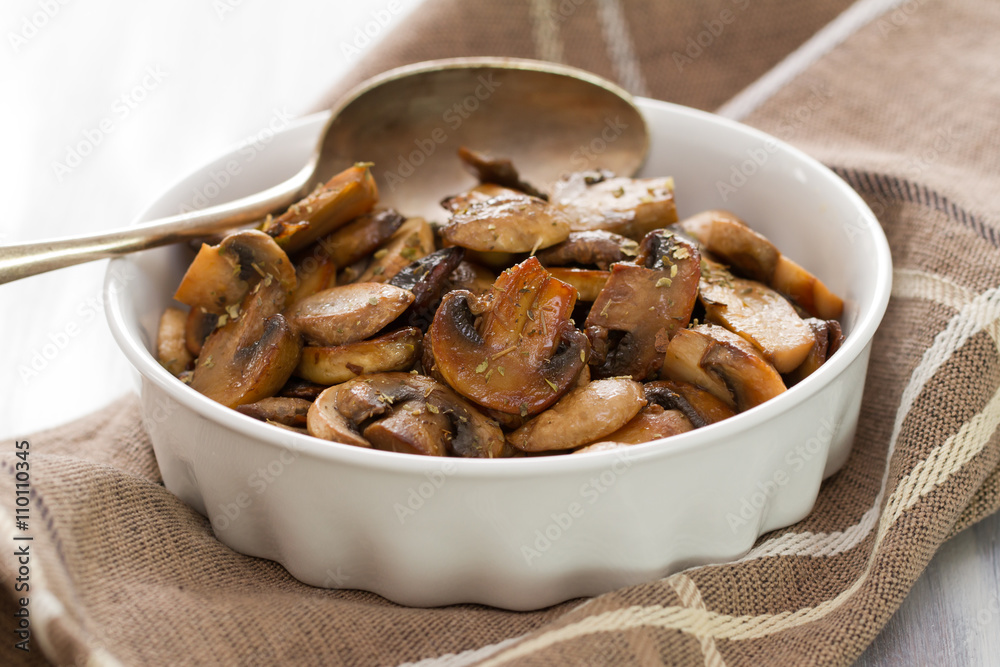 fried mushrooms on white dish on white wooden background fried mushrooms on white dish on white wooden background