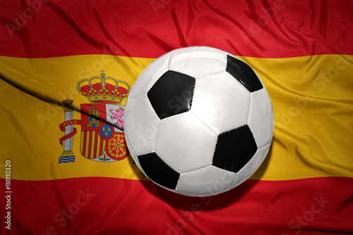 black and white football ball on the national flag of spain