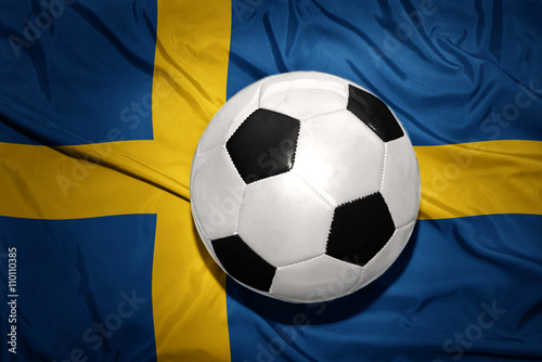 black and white football ball on the national flag of sweden