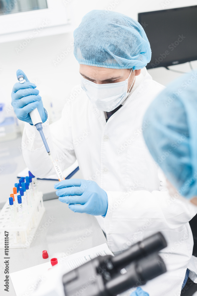 Cheerful two researchers are doing tests in lab Cheerful two researchers are doing tests in lab
