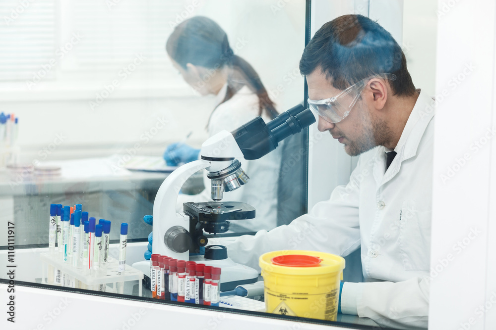 Experienced researcher is doing examination in lab Experienced researcher is doing examination in lab