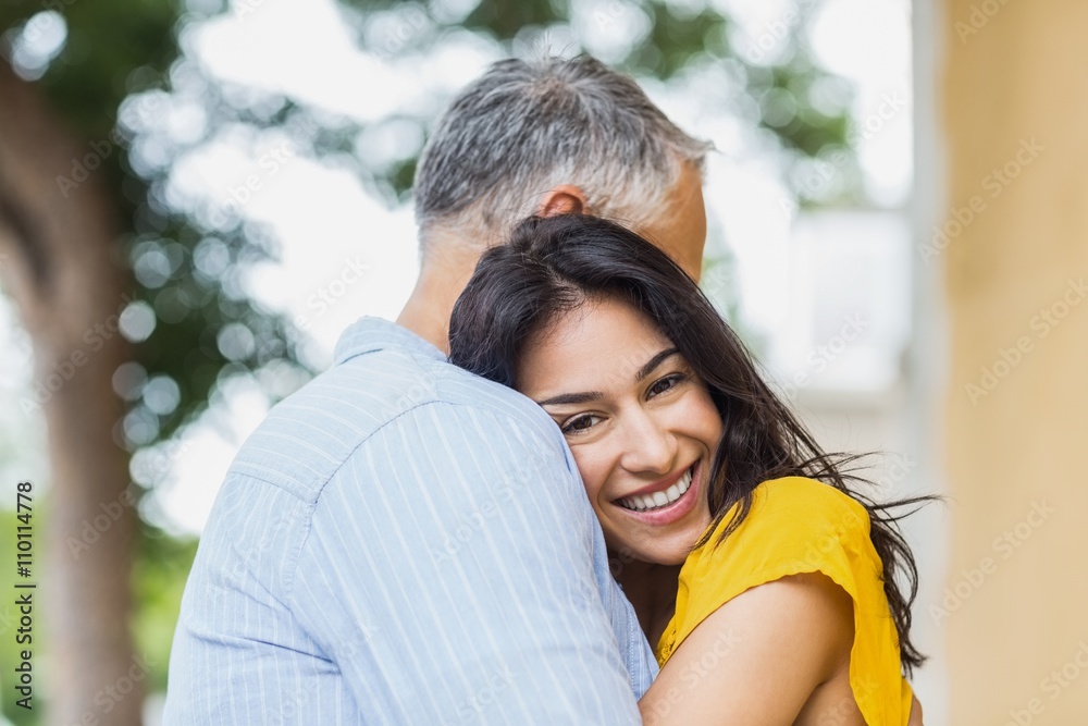 Fototapeta premium Portrait of woman hugging man
