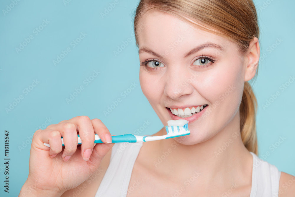 woman holds toothbrush with toothpaste cleaning teeth woman holds toothbrush with toothpaste cleaning teeth