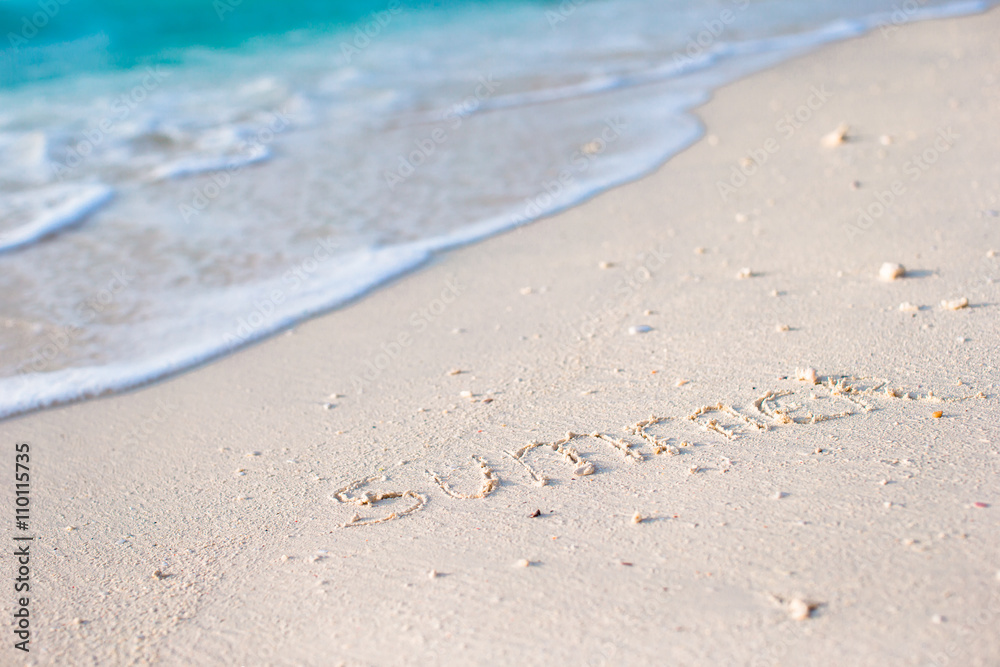 Holidays summer concept. The word summer written in the sand Holidays summer concept. The word summer written in the sand