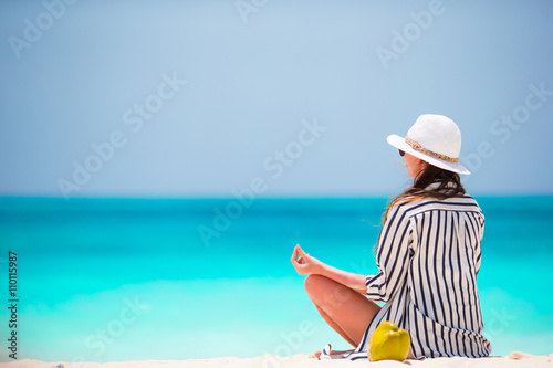 Body of beautiful woman in a meditation on the beach