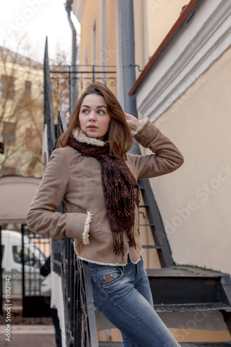 young attractive girl on the background of buildings