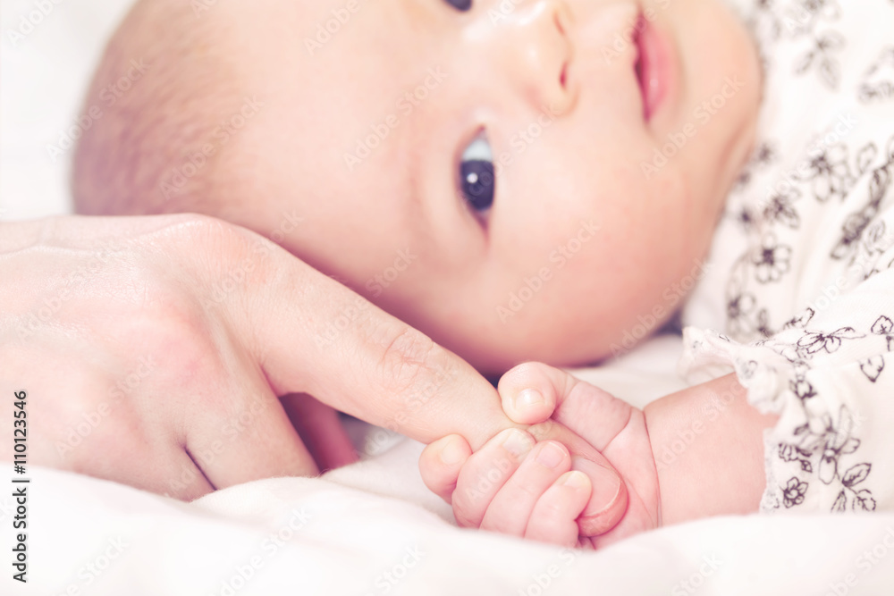 Baby girl grasping her parents finger Baby girl grasping her parents finger
