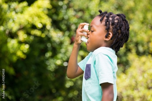 Boy using an asthma inhaler photo