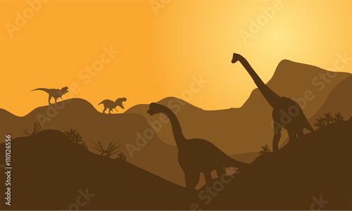 silhouette of brachiosaurus in hills