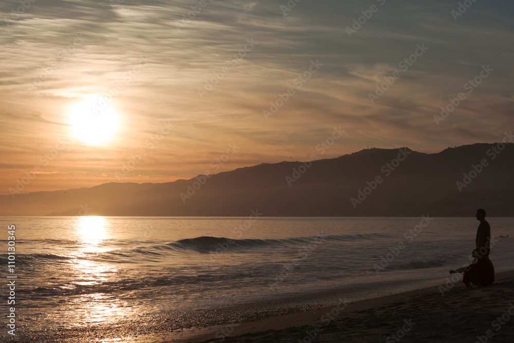 The Pacific ocean during sunset. Landscape with blue sea, the mountains and the dusk sky, the USA, Santa Monica.