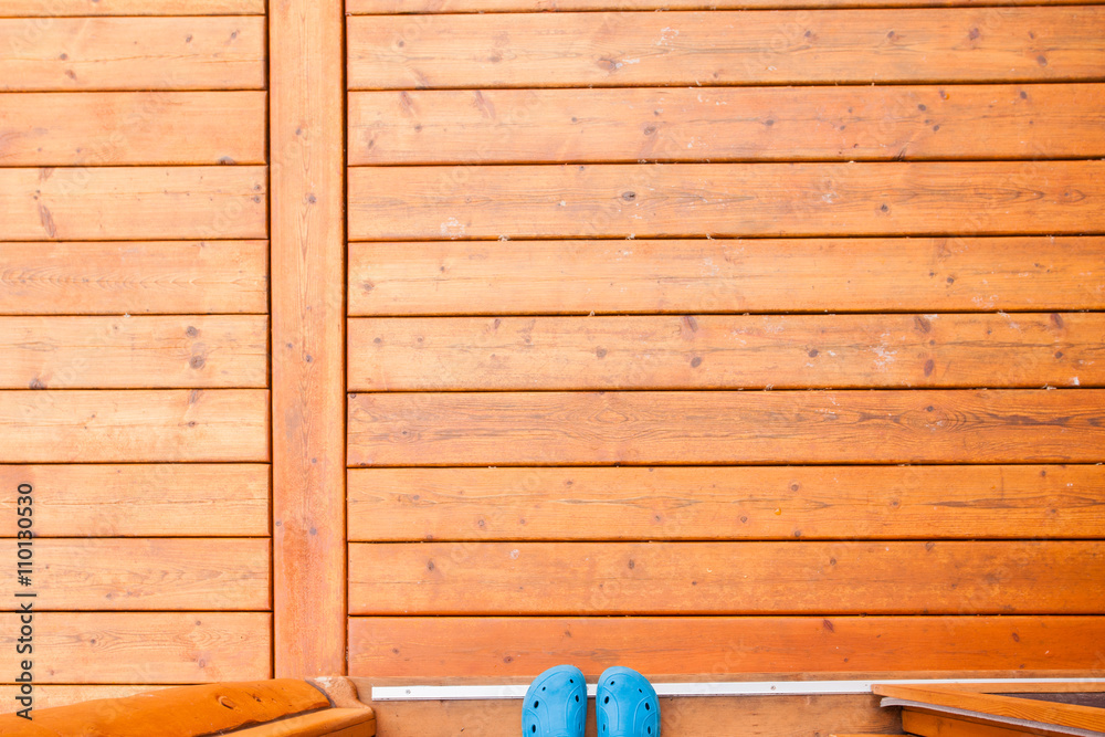Rubber shoe tips in doorway of wooden porch deck Rubber shoe tips in doorway of wooden porch deck