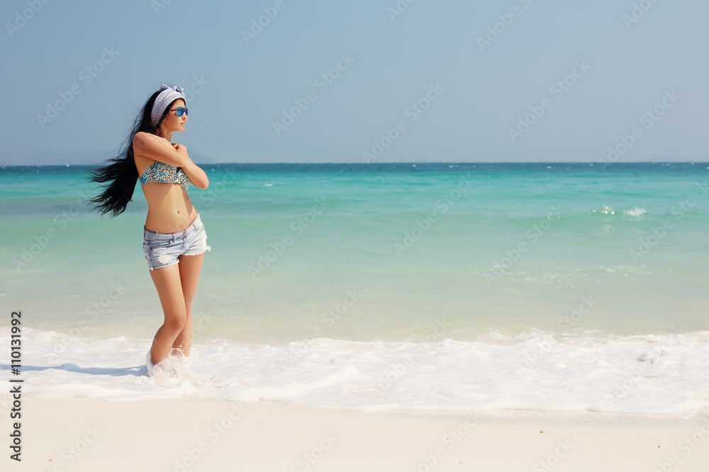 young girl with long hair on beautiful summer beach relaxing and enjoy summer and freedom