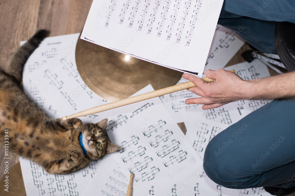 Drums conceptual image. Picture of man with stick and music notes