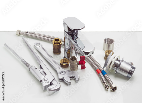 Mixer tap, plumber wrench, adjustable wrench and several plumbin