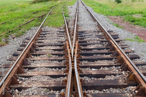 Railway tracks with railroad switch in a rural scene