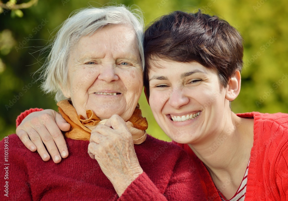 Grandmother and granddaughter. Young woman carefully takes care