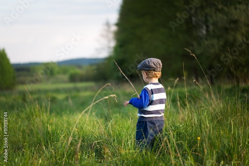 Baby boy playing on meadow