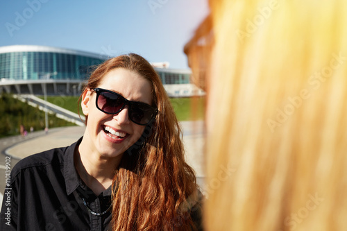 Positive human face expressions and emotions. Portrait of redhead student girl skipping school with her classmates on spring sunny morning. Female freelancer relaxing outdoor after meeting with client