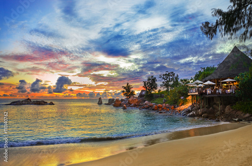 Cafe on tropical beach at sunset