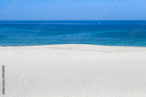 Beautiful white sand beach with blue sea and blue sky