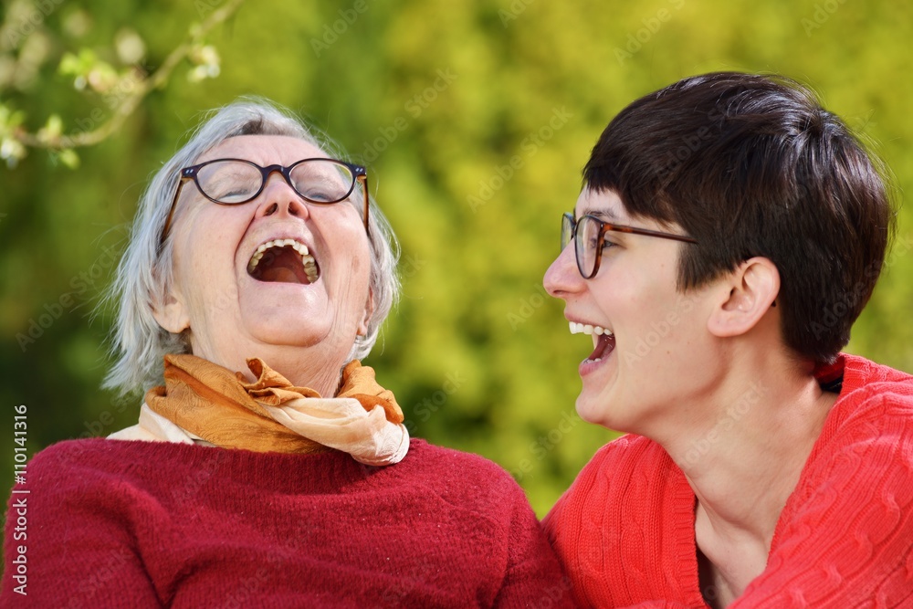 Grandmother and granddaughter. Young woman carefully takes care