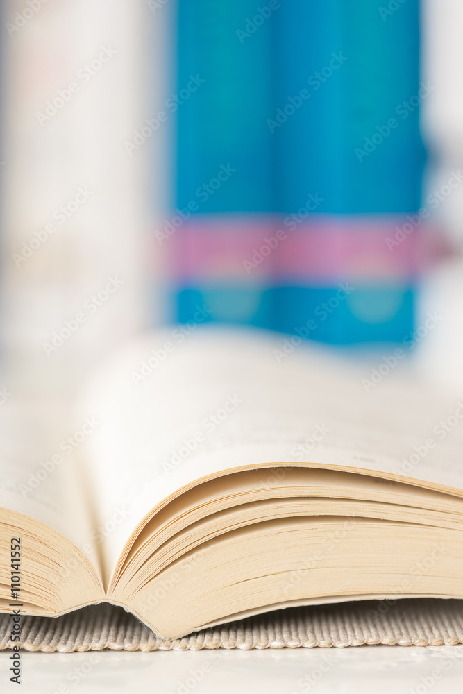 Macro shot of open book in library. Selective focus. Vertical view. Macro shot of open book in library. Selective focus. Vertical view.