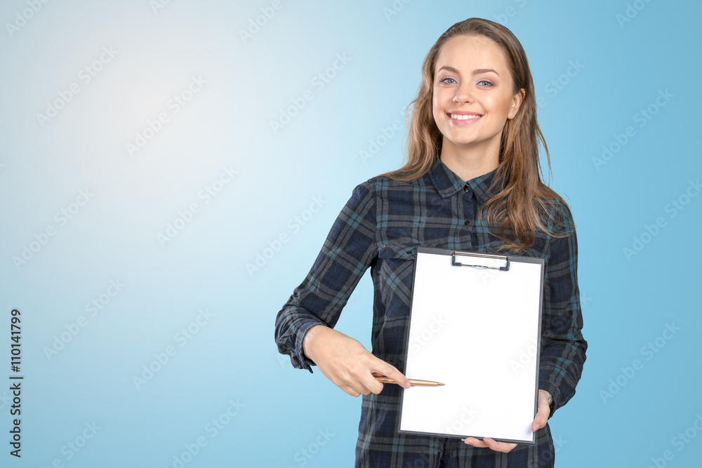 Fototapeta premium Cheerful attractive young woman showing blank clipboard