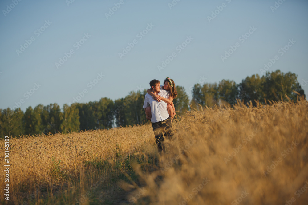 romantic happy couple go on a wheat field.