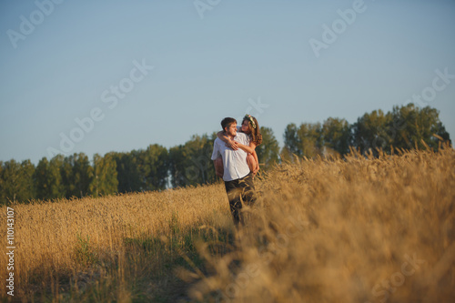 romantic happy couple go on a wheat field. © Diflope