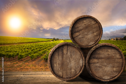 Red wine with barrel on vineyard in green Tuscany  Italy