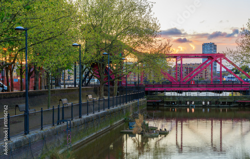 Red bascule bridge over channel between the River Thames and Surrey Water on Rotherhithe Street, Bermondsey, London photo