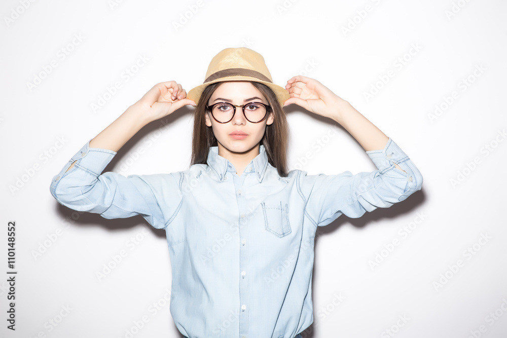 Portrait of beautiful young woman in glasses and funky hat over white background Portrait of beautiful young woman in glasses and funky hat over white background