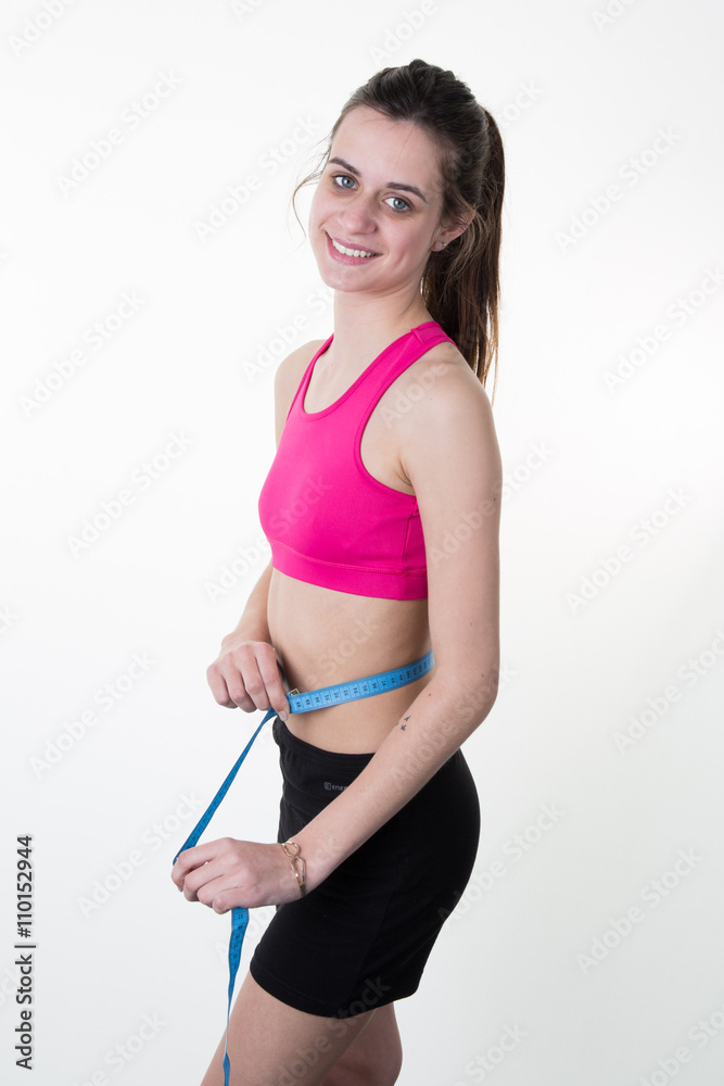 Happy joyful young woman girl measuring with tape Happy joyful young woman girl measuring with tape