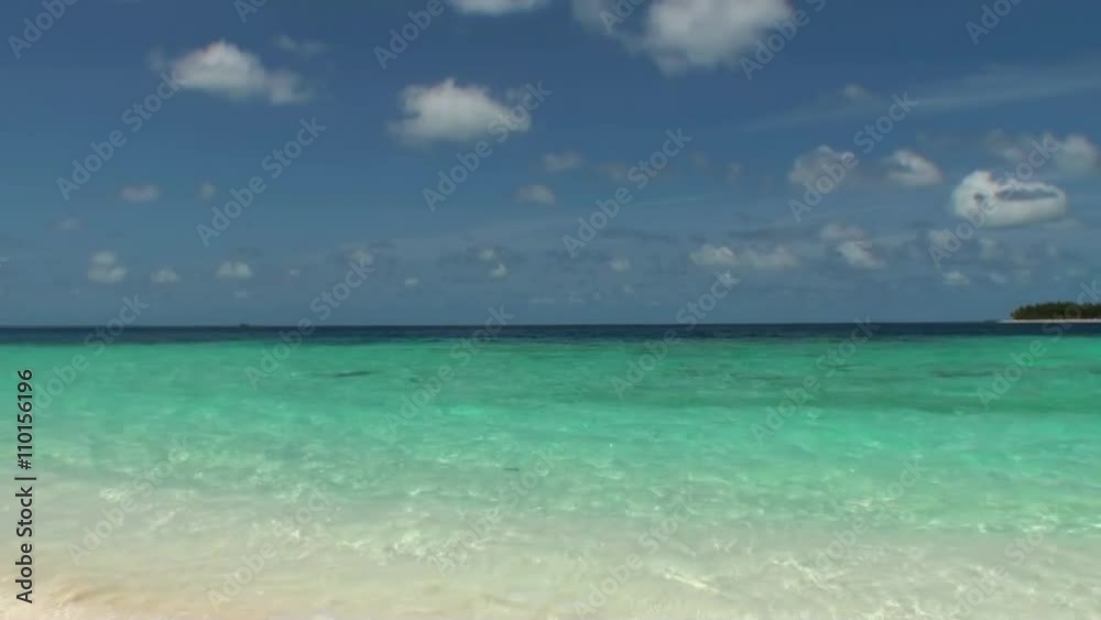 Sea waves surf on a sandy beach. Maldives. Suitable for background. Close up. Sea waves surf on a sandy beach. Maldives. Suitable for background. Close up.