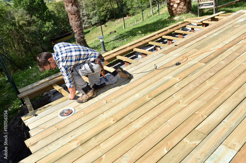 Carpenter building wooden deck photo