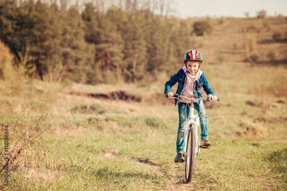 smiling little girl riding a bike 