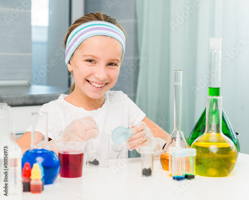 little girl with flasks for chemistry